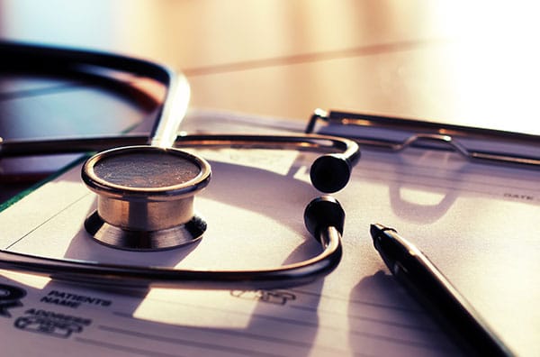 stethoscope sits on car accident insurance form