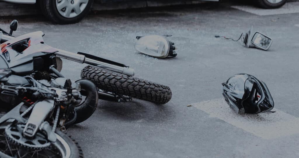 Helmet Laying on the Street Next to the Motorcycle After Accident