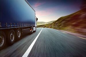 18 wheeler truck drives by on a road