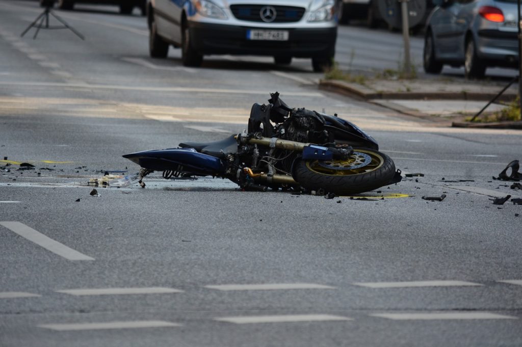 Damaged Motorcycle Laying in the Highway After Crash