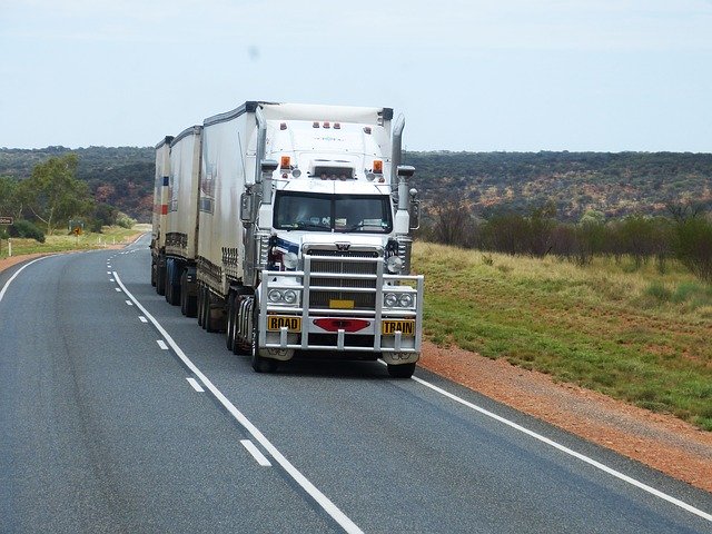 White 18-Wheeler Driving in Backroads