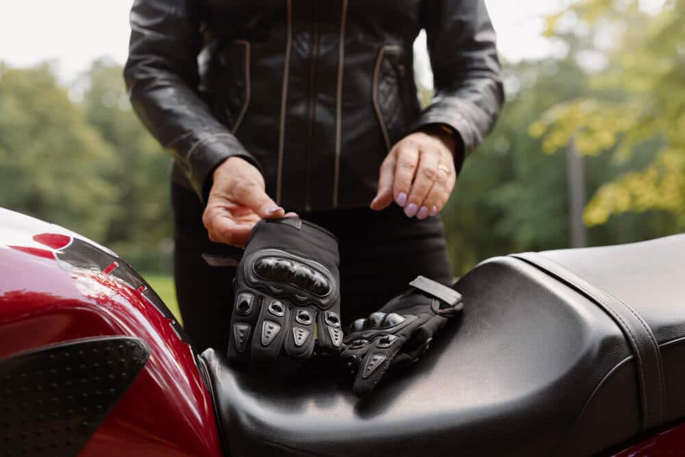 Motorcyclist Wearing Gloves at the Side of a Road