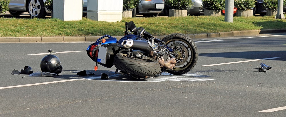 Motorcycle Laying On The Road With A Helmet